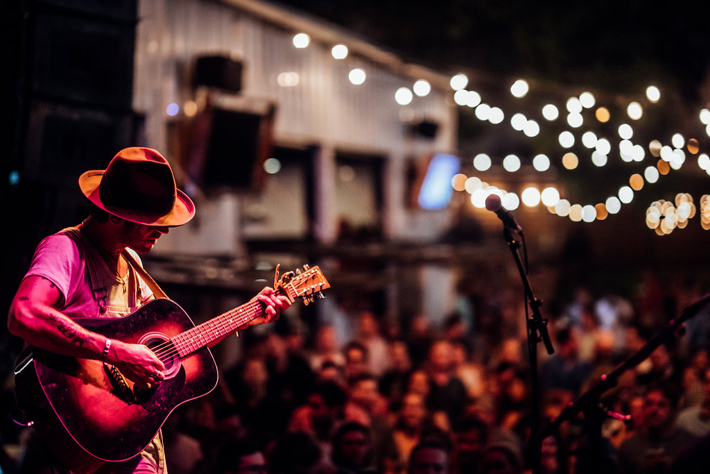 Men playing guitar at live music event