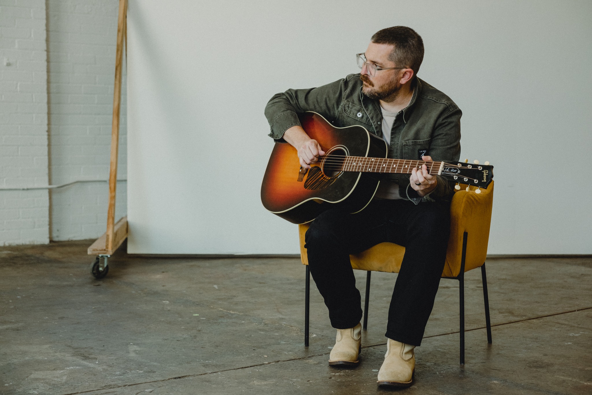 Cole Risner 3 Men sitting on chair playing guitar