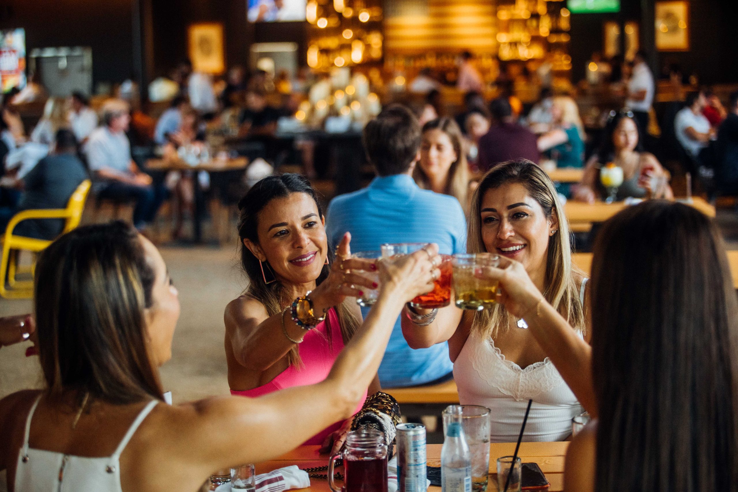 Women sitting around a table cheersing